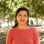 Jo Ann Martinez stands under a tree.