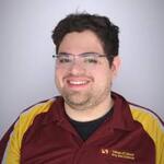 Ramon wearing ASU colorway polo in front of a white background